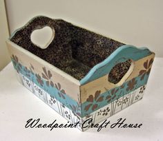 a blue and brown flowered box sitting on top of a white table