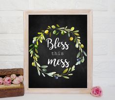 a framed chalkboard with the words,'bess this mess'and an olive wreath