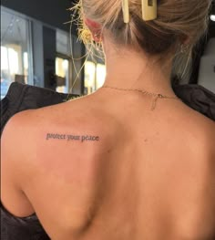 a woman with a tattoo on her back saying protect your peace and the word'protect your peace '