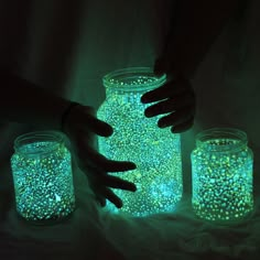 two jars with glow in the dark on them, one is filled with small stars