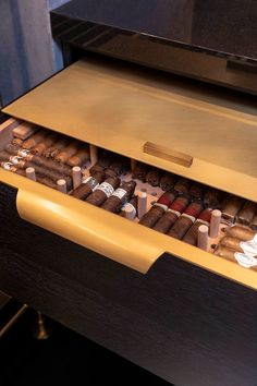 an open drawer filled with lots of different types of cigars