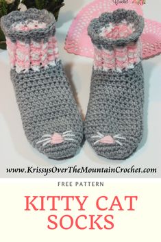 a crocheted cat boot with pink and gray trim