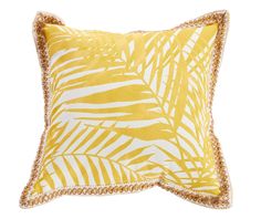 a yellow and white pillow with gold trimmings on the edges, featuring palm leaves