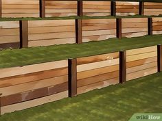 a row of wooden benches sitting on top of green grass