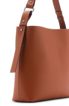 a brown leather handbag is shown on a white background with the strap down to it's side