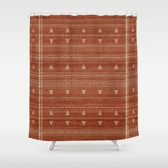 a shower curtain with an orange and white pattern on the front, featuring triangle shapes