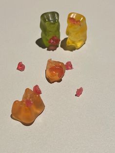 three gummy bears sitting next to each other on top of a white countertop