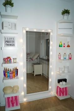 there is a mirror in the room with lights on it and shelves holding cosmetics products