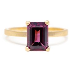 Made in 14k recycled gold, this stacking stone ring features an 8x6mm emerald cut rhodolite garnet. Pictured in:14k yellow gold2.07ct rhodolite garnet1.5mm wide Jennifer Dawes Design curates the most beautiful collection of diamond and precious gemstones available for all of our designs. Many of our stones are one of a kind and if a particular piece has sold, we will source gemstones in similar shape, size and color. Due to fluctuations in the gold and stone markets, prices are subject to change Garnet Ring Engagement, Rhodolite Garnet Ring, Wedding Lookbook, Garnet Engagement Ring, Rainbow Sapphires, Bridal Jewelry Collection, Garnet Ring, Rhodolite Garnet, Garnet Rings