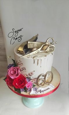 there is a cake with scissors and flowers on it