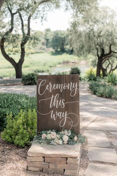 a wooden sign that says ceremony this way