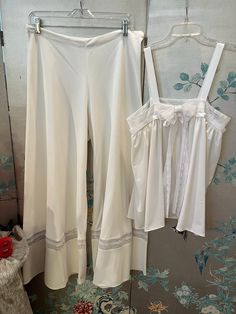 1960's vintage, Original Design, one of a kind, Baby Doll pajamas that could be worn as a outfit. The fabric is white, weighted, polyester jersey with white lace insets and grosgrain ribbon. The palazzo pants are, wonderfully, wide, 40" at hemline! And the top is, oh so, easy to wear. The lace band under the arms and over the bust is 36"(firm; no give) the length from shoulder to hem is 261/2". The waist band on the palazzo pants is 32" with some stretch. Machine wash Bridal Pyjamas, Vintage Pyjamas, Baby Doll Pajamas, Doll Pajamas, Victorian Bride, Vintage Loungewear, Ren Faire Costume, Bridal Pajamas, Vintage Pajamas