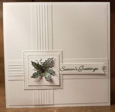 a christmas card with holly leaves on it