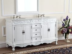 a white bathroom vanity with two sinks and mirrors on the wall next to a rug