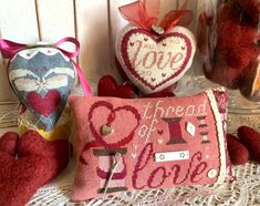 two heart shaped pillows sitting on top of a table next to some other hearts and decorations