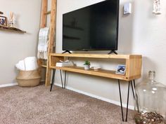 a flat screen tv sitting on top of a wooden shelf