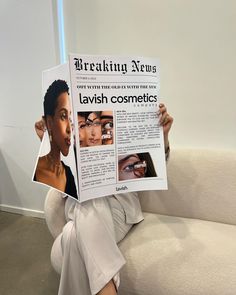 a woman sitting on a couch holding up a news paper with photos of her face