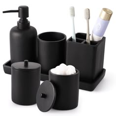 black bathroom accessories including toothbrushes, soap dispenser and cup