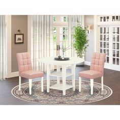 a white table with two pink chairs and a rug in front of the door way