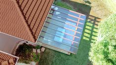 an aerial view of a house with red shingles