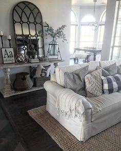 a living room filled with furniture and lots of windows