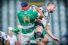 two rugby players colliding for the ball during a game