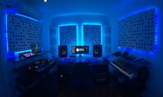 a recording studio with blue lighting and sound equipment