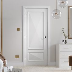 a bedroom with white walls and carpeted flooring next to a large mirror on the wall