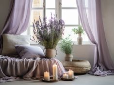 candles and lavender flowers in front of a window