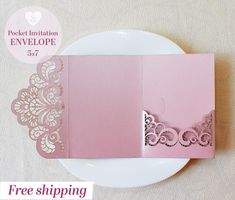 a pink and gold wedding card on a white plate with the word free shipping written below it