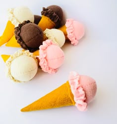 several ice cream cones are arranged on top of each other in different colors and shapes