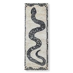 a white and black runner rug with a snake on it