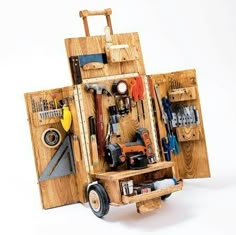 a wooden toolbox with tools in it and wheels on the side, sitting upright against a white background