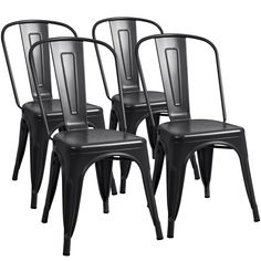 four black metal dining chairs against a white background