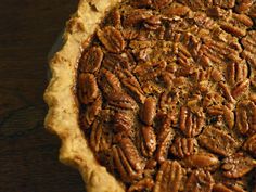 a pecan pie sitting on top of a wooden table