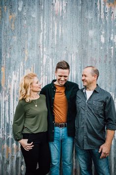 three people standing next to each other in front of a wall with the words, adult family photos at allbook recreation center