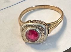 "14K Antique ring man made ruby in a white and yellow setting.  Condition is good, there is minor wear on ruby with age visible with magnification of little consequence-photos show details.  Size 6, wt.- 2.3 grams, approx top 1/3\" by 1/4\".  Lovely old setting open work, filigree  with white gold top and bezel for approx 5mm ruby." Antique 14k Stamped Yellow Gold Ruby Ring, Antique Gold Ruby Ring With Bezel Setting, Antique Red 14k Gold Signet Ring, Antique Ruby Signet Ring, Antique Red Signet Ring In 14k Gold, Antique Hallmarked Ruby Signet Ring, Antique Yellow Gold Ruby Ring, Antique Ruby Ring In Yellow Gold, Antique 14k Gold Ruby Ring With Center Stone