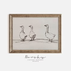 three geese are standing in front of a framed drawing