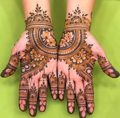 two hands with henna designs on them