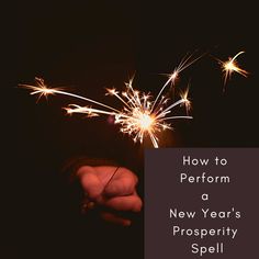 a hand holding a sparkler with the words how to perform a new year's prosperity spell