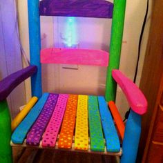 a brightly colored wooden chair in a room