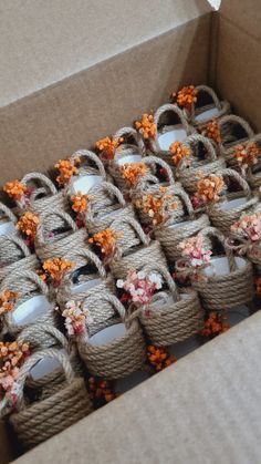 a box filled with lots of baskets and flowers on top of each other's sides