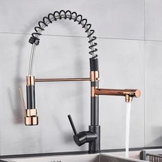 a kitchen faucet that is connected to a sink