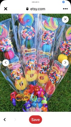 a bunch of lollipops are wrapped in plastic and sitting on the grass