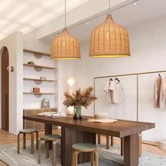 a dining room table with stools and hanging lights