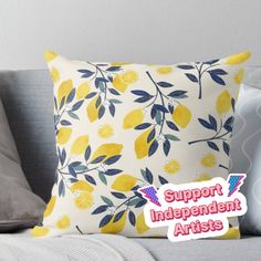 a pillow with the words support independent artists on it sitting on a couch next to pillows