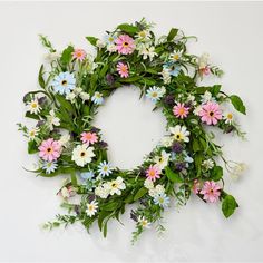 a wreath made out of flowers and greenery