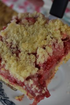 a piece of cake sitting on top of a white and blue plate next to a fork