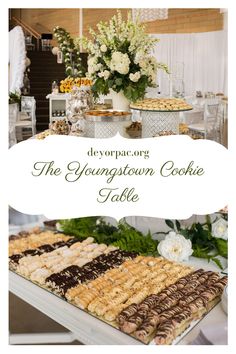 a table topped with lots of desserts next to a white and green flower centerpiece