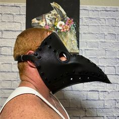 a man wearing a black mask with holes on it